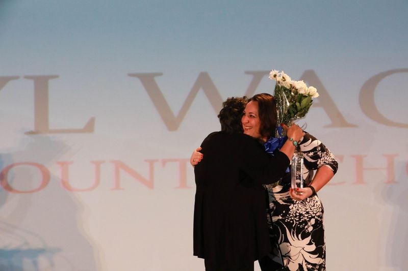 Cheryl Wagnon (left) hugs her daughter Katie when the two have a surprise meeting on the stage at the Celebrating Nurses Excellence Awards. Photo: Cindy Harter Photography