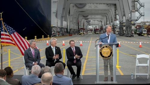 Georgia Gov. Brian Kemp, right, speaks during a visit to the Port of Savannah with Congressmen Sam Graves, center right, Buddy Carter, left, and Mike Collins, center left, at the Georgia Ports Authority's Garden City Terminal, Monday, March, 25, 2024, in Savannah, Ga. Improvements to deepen and widen the harbor are needed before vessels with a capacity greater than 16,000 twenty-foot equivalent container units can call on the port. (GPA Photo/Stephen B. Morton)