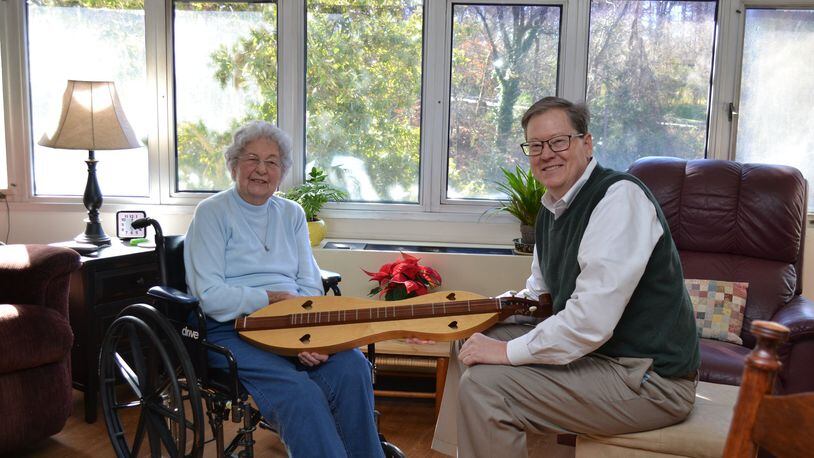Betty Tarr, an independent living resident at Wesley Woods Towers, is shown here chatting with her son Sam about a handmade dulcimer that was a gift from her late husband. She didn’t wait for her children to have “the talk” with her about moving from her home in Hartwell. She knew it was no longer safe for her to live alone. CONTRIBUTED
