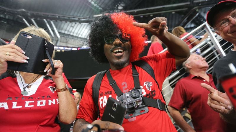 Fans use various record devices as the first Atlanta Falcons game at Mercedes-Benz Stadium gets under way Saturday, Aug. 26, 2017, in Atlanta. The Falcons faced the Arizona Cardinals in an exhibition game.