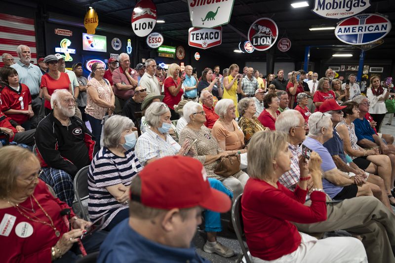 Attendees at a campaign stop held by Herschel Walker, the retired football star and Republican senate candidate, at a car dealership in rural in Ocilla, Georgia on July 19, 2022. The uneventful outing was noteworthy for Walker, whose candidacy has been rocked by a series of damaging reports about his business record and personal life.  (Nicole Craine/The New York Times)..