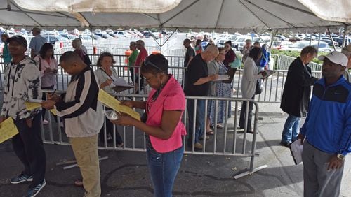 People lined up for  early voting outside the Gwinnett County Voter Registrations and Elections Office in Lawrenceville on Thursday, October 18, 2018.