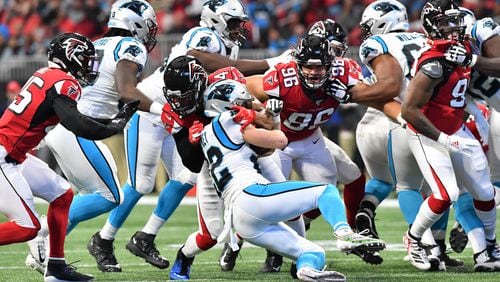 December 8, 2019 Atlanta - Carolina Panthers running back Christian McCaffrey (22) is brought down by Atlanta Falcons defensive end Vic Beasley (44) during the first half in a NFL football game at Mercedes-Benz Stadium on Sunday, December 8, 2019. (Hyosub Shin / Hyosub.Shin@ajc.com)