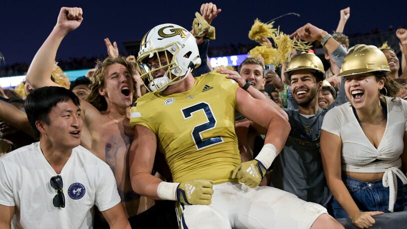 Georgia Tech’s Dylan Leonard (2) celebrates with fans after beating Duke 23-20 in overtime Saturday, Oct. 8, 2022 at Bobby Dodd Stadium. (Daniel Varnado/For the AJC)