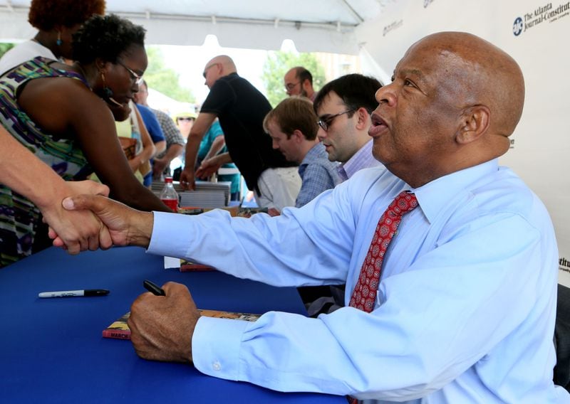 U.S. Rep. John Lewis (right) greeted visitors and signed his new book "March: Book One" during the 2013 AJC Decatur Book Festival in downtown Decatur on Saturday.