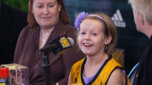 Cate Zavitz, 8, center, talks to the media while sitting with her mother, Sam Zavitz, left, and KSU women’s basketball coach Agnus Berenato at Kennesaw State University, Thursday, Jan. 26, 2017, in Kennesaw, Ga. The Kennesaw State women’s basketball team adopted Zavitz, who has a skin disease, through the Team IMPACT organization. BRANDEN CAMP/SPECIAL