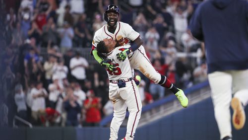 Atlanta Braves center fielder Michael Harris II (top) celebrates with catcher Chadwick Tromp after Harris hit the game-ending walk-off double scoring Ronald Acuna during the 10th inning against the Miami Marlins at Truist Park, Wednesday, April 24, 2024, in Atlanta. The Braves won 4-3. (Jason Getz / AJC)
