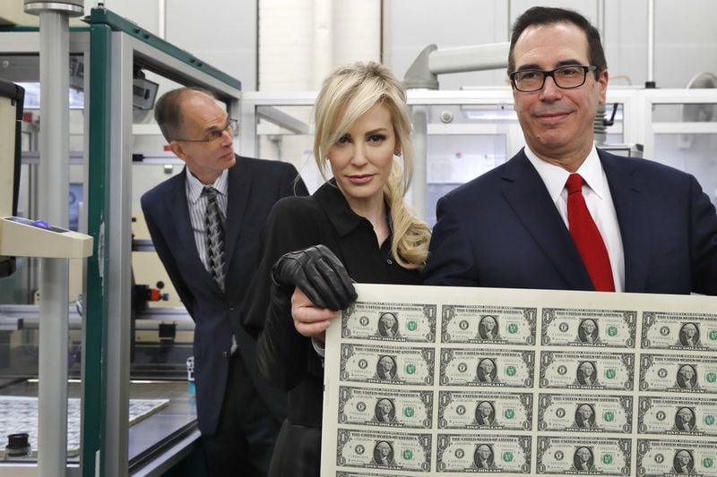 Personal signatures are slowly losing relevance. U.S. Treasury Secretary Steven Mnuchin, right, (shown with his wife Louise Linton) used block letters rather than a traditional signature on new dollar bills. 
