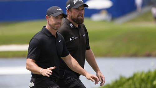 Rory McIlroy, of Northern Ireland, acknowledges the crowd as he walks onto the ninth green with teammate Shane Lowry, of Ireland, during the second round of the PGA Zurich Classic golf tournament at TPC Louisiana in Avondale, La., Friday, April 26, 2024. (AP Photo/Gerald Herbert)