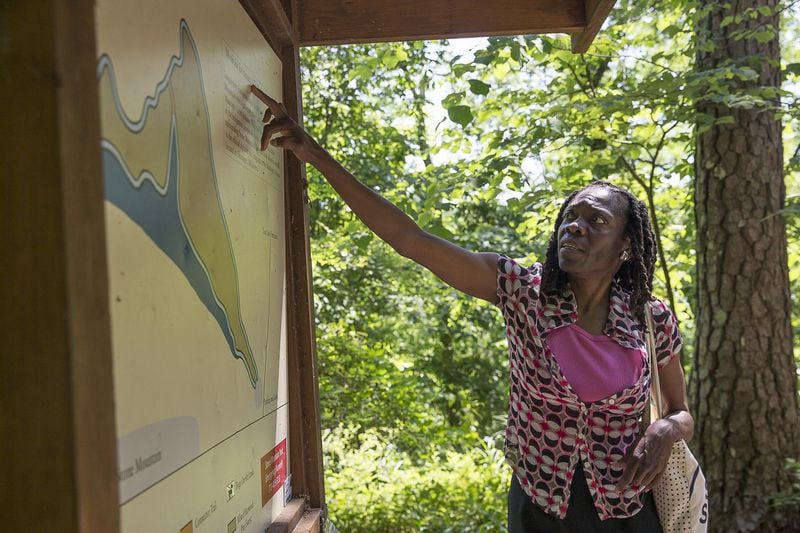 05/08/2019 — Stone Mountain, Georgia — Melissa Best, program coordinator for the Georgia Historic Preservation division, examines a map of the Trail of Muscogee, near the site at Stone Mountain Park, Wednesday, May 8, 2019. (ALYSSA POINTER/ALYSSA.POINTER@AJC.COM)