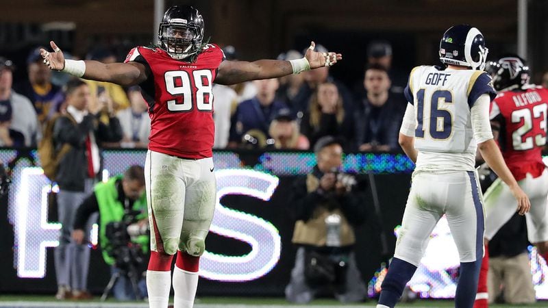 Falcons defensive end Takkarist McKinley celebrates stopping the Los Angeles Rams on fourth down while quarterback Jared Goff walks off the field in the final minutes of a 26-13 victory in the NFC wild card game in Los Angeles.