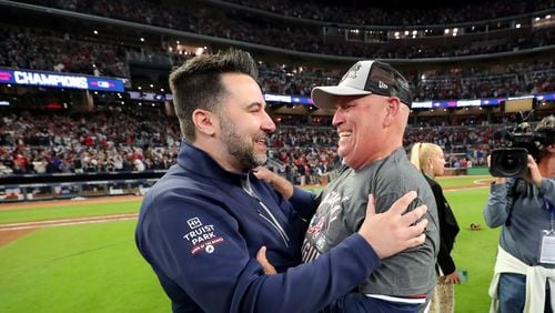 Braves general manager Alex Anthopoulos, left, and manager Brian Snitker celebrate the Braves' 4-2 win against the Los Angeles Dodgers to advance to the World Series in game 6 at the National League Championship Series at Truist Park, Saturday October 23, 2021, in Atlanta. Curtis Compton / curtis.compton@ajc.com