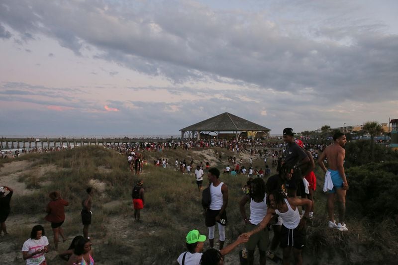 People leaving the beach in a hurry after, apparently, someone flashed their gun at another person during Orange Crush on Tybee Island, Saturday, April 22.