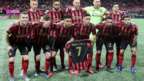 Atlanta United players hold a Martinez jersey as they take the field to play FC Cincinnati in a MLS soccer match on Saturday, March 8, 2020, in Atlanta.   Curtis Compton ccompton@ajc.com