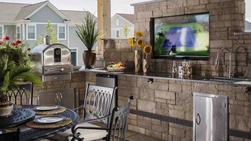 A high-tech outdoor kitchen and TV transform a basic outdoor patio. Contributed by Belgard