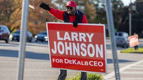 Larry Johnson, a candidate for DeKalb CEO, campaigns at the corner of Memorial Drive and Covington Highway in Belvedere Park on Tuesday, March 19, 2024. (Arvin Temkar / arvin.temkar@ajc.com)