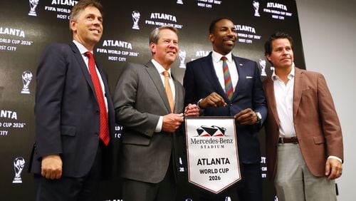 Dietmar Exler, Chief Operating Officer of Mercedes-Benz Stadium, Georgia Governor Brian Kemp, left, Atlanta Mayor Andre Dickens, and Dan Corso of Atlanta Sports Council, take the stage during the Host City announcement press conference for the 2026 World Cup at Mercedes-Benz Stadium on Thursday, June 16, 2022, in Atlanta. (Curtis Compton/The Atlanta Journal-Constitution/TNS)