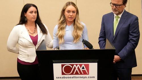 FILE - Tennis player Kylie McKenzie, middle, with her attorney Robert Allard, right, and victim advocate Jancy Thompson, left, speaks to reporters at a news conference in Phoenix Tuesday, March 29, 2022. McKenzie has been awarded $9 million in damages by a jury in federal court in Florida after accusing the U.S. Tennis Association of failing to protect her from a coach she said sexually abused her at one of its training centers when she was a teenager. “I couldn’t be happier with the outcome. I feel validated,” McKenzie said in a statement emailed Tuesday, May 7, 2024, by one of her lawyers, Amy Judkins. (Michael Chow/The Arizona Republic via AP, File)