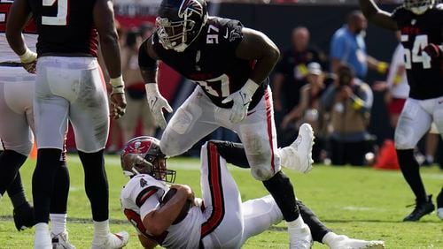 Falcons defensive end Grady Jarrett (97) takes down Tampa Bay Buccaneers quarterback Tom Brady (12) during the second half of an NFL football game Sunday, Oct. 9, 2022, in Tampa, Fla. Jarrett was called for a penalty. (AP Photo/Chris O'Meara)