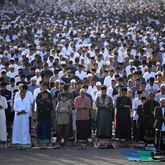 Muslim men perform an Eid al-Fitr prayer marking the end of the holy fasting month of Ramadan on a street in Jakarta, Indonesia, Wednesday, April 10, 2024. (AP Photo/Dita Alangkara)
