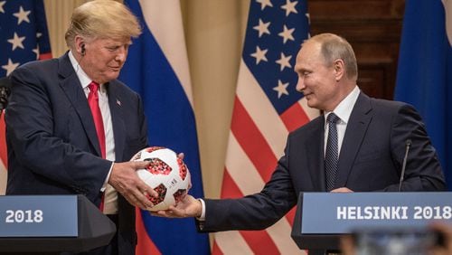 Russian President Vladimir Putin hands U.S. President Donald Trump a World Cup football during a joint press conference after their summit on Monday in Helsinki, Finland. Chris McGrath/Getty Images