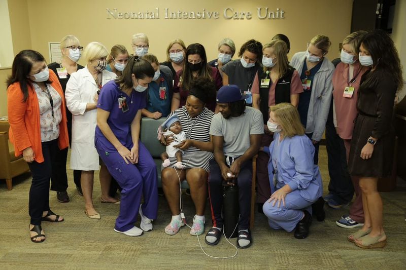 Baby Jayla and her parents, surrounded by the team of doctors and nurses that cared for the child born 18 weeks early. The team discussed the medical plan for Jayla every day, with some staff members checking in even on their days off. They consulted with doctors at the University of Iowa Stead Family Children’s Hospital and Children’s Healthcare of Atlanta. (Contributed)