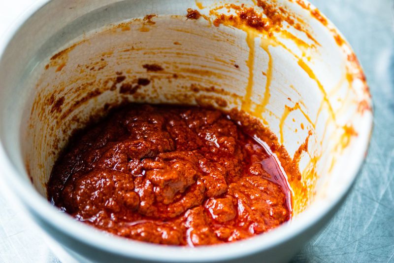 The spicy red-chile paste known as harissa comes from northwest Africa. New Orleans chef Alon Shaya concocts his with rehydrated dried ancho, guajillo and arbol chili peppers. Use it to make his Watermelon and Feta Salad or as a dipping sauce for Fried Watermelon Rind. (Photo contributed by Henri Hollis; food styling by Wendell Brock)