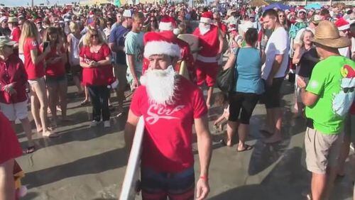 More than 837 Santa-suit wearing surfers caught waves off Cocoa Beach, Florida. (Photo: WFTV.com)