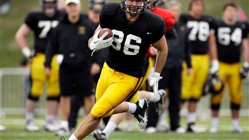 Iowa tight end C.J. Fiedorowicz runs with the ball after catching a pass during NCAA college football practice at Valley High School Stadium, Sunday, April 14, 2013, in West Des Moines, Iowa. (AP Photo/Charlie Neibergall) Iowa tight end C.J. Fiedorowicz runs with the ball after catching a pass during NCAA college football practice at Valley High School Stadium, Sunday, April 14, 2013, in West Des Moines, Iowa. (AP Photo/Charlie Neibergall)