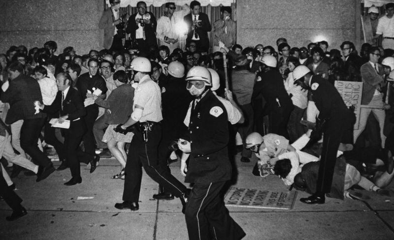 FILE - Chicago Police attempt to disperse demonstrators outside the Conrad Hilton, Democratic National Convention headquarters, Aug. 29, 1968, in Chicago. As pro-Palestinian demonstrations escalate on college campuses around the country, critics of President Joe Biden’s handling of the Israel-Hamas war suggest this summer’s 2024 Democratic National Convention could be marred by protests and scenes of chaos that undermine his reelection. It raises the specter of a replay of 1968’s Democratic convention in Chicago, where a violent police crackdown created indelible scenes of chaos. (AP Photo/Michael Boyer, File)