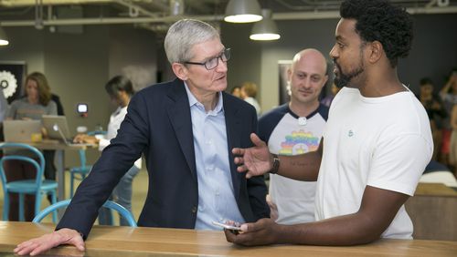 Apple CEO Tim Cook, left, gets a demonstration of the Localeur app from Localeur founder and CEO Joah Spearman at Capital Factory in Austin, Texas, on Friday August 25, 2017. JAY JANNER / AMERICAN-STATESMAN