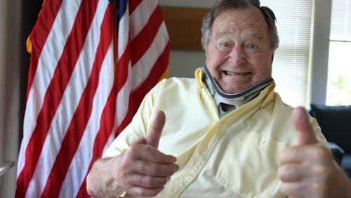 In this Thursday, July 30, 2015, photo provided by the Office of George H. W. Bush, former President George H.W. Bush wears a neck brace at his summer home in Kennebunkport, Maine. The 91-year-old tweeted the photo showing him in the brace and giving two thumbs up Thursday. Bush fractured a bone in his neck when fell there on July 15. Doctors are letting the fractured vertebra heal on its own over the next several months.