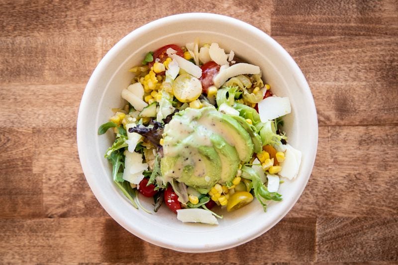 Karv Kitchen Corn Avocado Salad with tomato, cucumber, roasted corn, sliced avocado, kefalotyri cheese, and roasted Hungarian pepper. (Mia Yakel for The Atlanta Journal-Constitution)