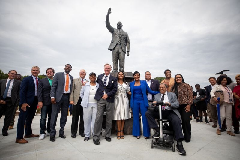 Councilmembers, Mayor Keisha Bottoms, former mayor Andrew Young, and others pose with the new John Lewis statue at Rodney Cook, Sr. Park in Vine City in Atlanta, GA., on Wednesday, June 7, 2021. (Photo/ Jenn Finch for the Atlanta Journal Constitution)