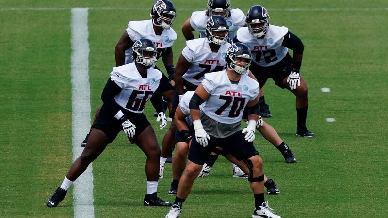 The Atlanta Falcons offensive line is led by Jake Matthews (70) as they stretch during the team's mini camp Tuesday, June 8, 2021, in Flowery Branch. (John Bazemore/AP)