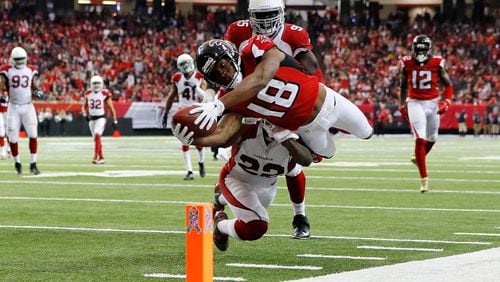 ATLANTA, GA - NOVEMBER 27: Taylor Gabriel #18 of the Atlanta Falcons dives for the pylon past Tony Jefferson #22 of the Arizona Cardinals to score a touchdown during the second half at the Georgia Dome on November 27, 2016 in Atlanta, Georgia. (Photo by Kevin C. Cox/Getty Images)