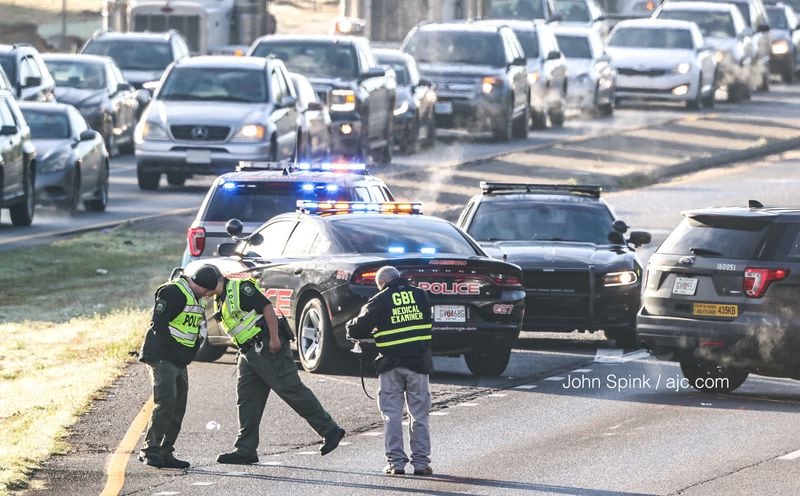Investigators blocked the southbound lanes of Tara Boulevard to traffic Tuesday morning to investigate a deadly crash involving a pedestrian. JOHN SPINK / JSPINK@AJC.COM