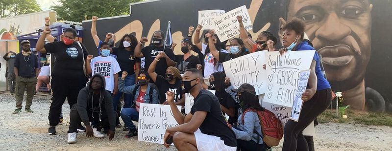 Atlantans near a George Floyd memorial react to Tuesday's verdict. (J.D. Capelouto / Atlanta Journal-Constitution)