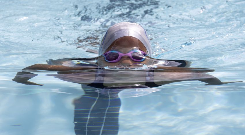 Sanaya McClendon, 8, competes in the breast stroke in a swim meet at Leslie Beach Club in Atlanta on Saturday, May 21, 2022.    According to the USA Swimming Foundation, while most Americans learn how to swim during childhood, 64% of Black children in America have little to no swimming ability. (Bob Andres / robert.andres@ajc.com)