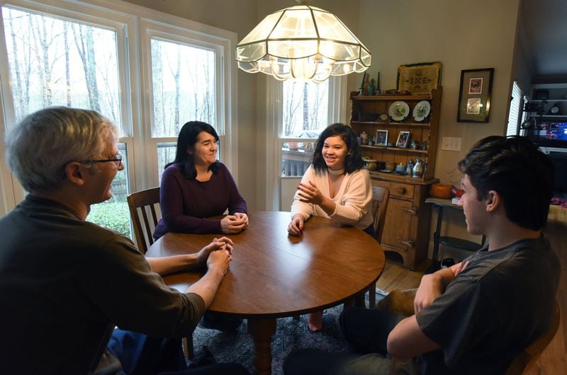 Tom and Debbie Crittenden talk at home with their children, Lexy and Mark (right), whom they adopted in November 2017. Lexy and Mark are graduating from high school this year and making plans for the next step in their education. HYOSUB SHIN / HYOSUB.SHIN@AJC.COM