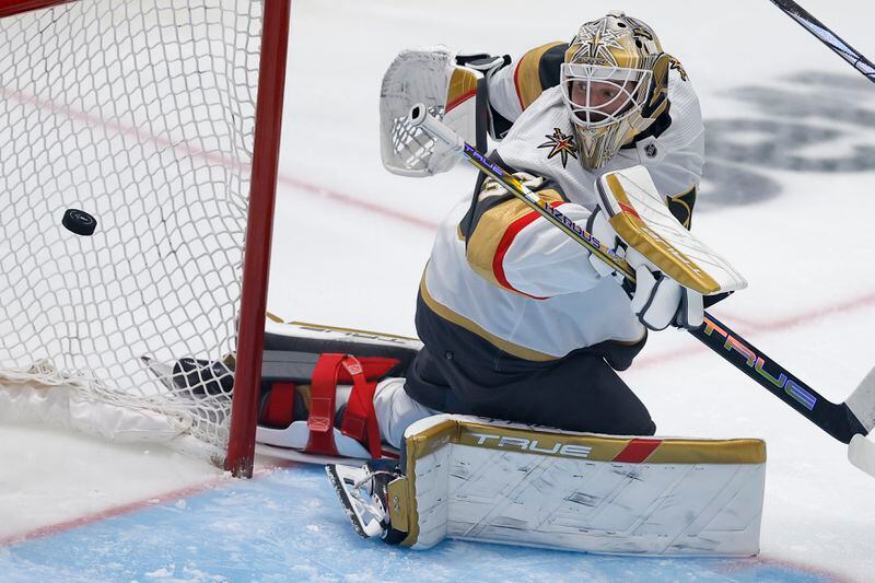 Vegas Golden Knights goaltender Adin Hill eyes the puck on a scoring shot by Dallas Stars center Radek Faksa during the third period in Game 7 of an NHL hockey Stanley Cup first-round playoff series, Sunday, May 5, 2024, in Dallas. (AP Photo/Brandon Wade)