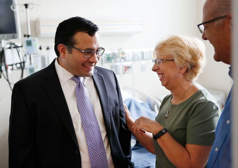 August 2, 2019, 2019 - Atlanta - Dr. Aneesh Mehta (from left) speaks with Nancy Writebol and her husband, David, in the room in the Serious Communicable Diseases Unit where she was treated. Members of the Emory University Hospital medical team who successfully treated the first patients with Ebola virus disease in the United States reunited with former patients Dr. Kent Brantly, and Nancy Writebol  on Friday, Aug. 2. This marks the fifth anniversary of Dr. Brantly's arrival at Emory University Hospital as the first patient with Ebola virus disease to be treated in the U.S.   Bob Andres / robert.andres@ajc.com