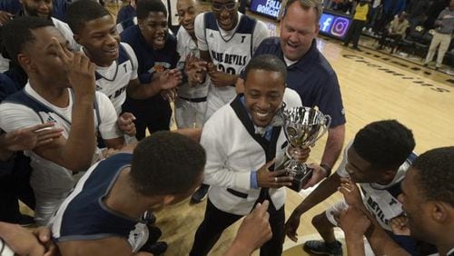 Eric Holland holds the state championship trophy that he and Tift County won in March at Georgia Tech. Holland, who won two state titles at Tift, is the new principal at Rome High School.