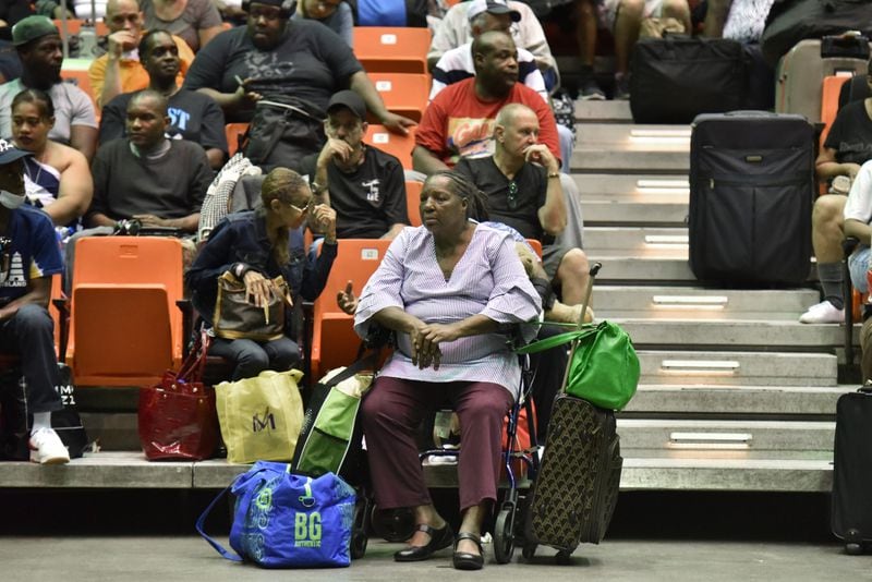 September 3, 2019 Savannah - Hundreds of local residents including Brown Mary (center) sit and wait inside the Savannah Civic Center to get a free transportation under mandatory evacuation ahead of Hurricane Dorian on Tuesday, September 3, 2019. Chatham Area Transit (CAT) provided free transportation to residents without private transportation to the Savannah Civic Center to assist in the mandatory evacuation of Chatham County. (Hyosub Shin / Hyosub.Shin@ajc.com)