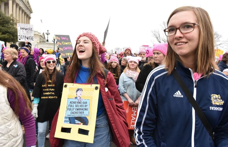 January 21, 2017 Washington D.C. - Katie Adams (left), 18, and Emmie Poth-Nebel, 17, of Decatur, walk toward the U.S. Capitol for the Womenâs March on Washington on Saturday, January 21, 2017. They rode a bus overnight to participate this event. The Womenâs March on Washington is a grassroots effort comprised of dozens of independent coordinators at the state level. HYOSUB SHIN / HSHIN@AJC.COM