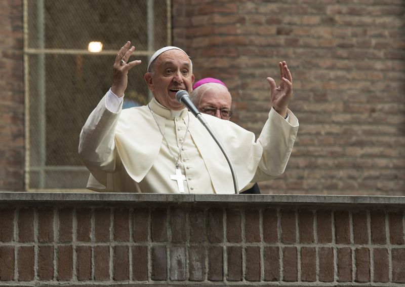 In this pool photo taken Sunday, June 21, 2015, and made available Monday, June 22, Pope Francis salutes upon arrival at the hospital Cottolengo of Turin, northern Italy, Sunday, June 21, 2015. Pope Francis earlier prayed in front of the Holy Shroud, the 14 foot-long linen revered by some as the burial cloth of Jesus, on display at the Cathedral of Turin. (L' Osservatore Romano/Pool Photo via AP)