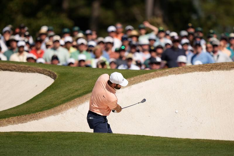 Scottie Scheffler hits from the bunker on the seventh hole during final round at the Masters golf tournament at Augusta National Golf Club Sunday, April 14, 2024, in Augusta, Ga. (AP Photo/Charlie Riedel)