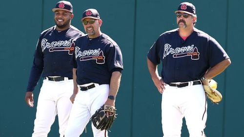 Braves new bench coach, Walt Weiss (center) has a spring moment with former Braves outfielder Andruw Jones (left), and catching coach Sal Fasano. (Curtis Compton/ccompton@ajc.com)
