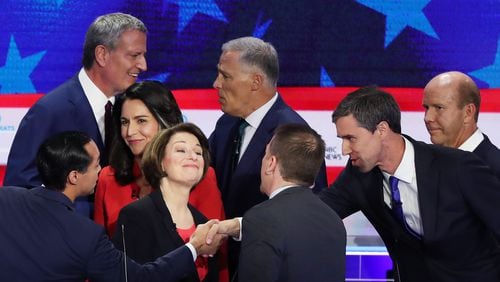 Chuck Todd of NBC News greets Sen. Amy Klobuchar (D-MN), former housing secretary Julian Castro, former Texas congressman Beto O'Rourke and other candidates after the first night of the Democratic presidential debate on June 26, 2019 in Miami, Florida. A field of 20 Democratic presidential candidates was split into two groups of 10 for the first debate of the 2020 election, taking place over two nights at Knight Concert Hall of the Adrienne Arsht Center for the Performing Arts of Miami-Dade County, hosted by NBC News, MSNBC, and Telemundo. (Photo by Joe Raedle/Getty Images)