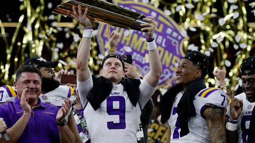 In January, LSU revels in beating Clemson for the national championship, with quarterback Joe Burrow in charge of the trophy. (AP Photo/Sue Ogrocki, File)